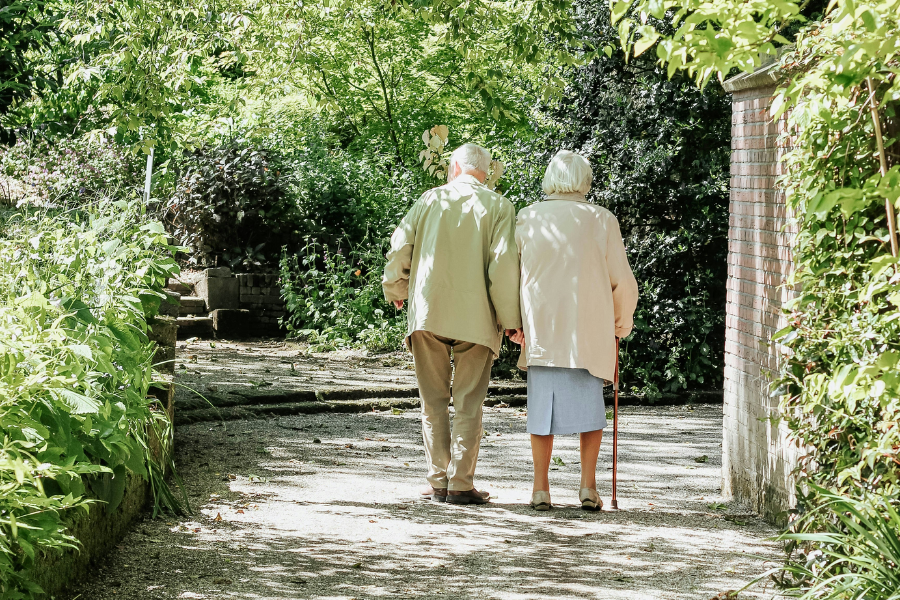 Image of an elderly couple walking together